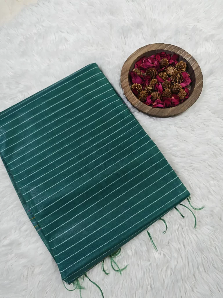 Folded Green Bhagalpur Silk Saree with narrow white stripes and matching tassels