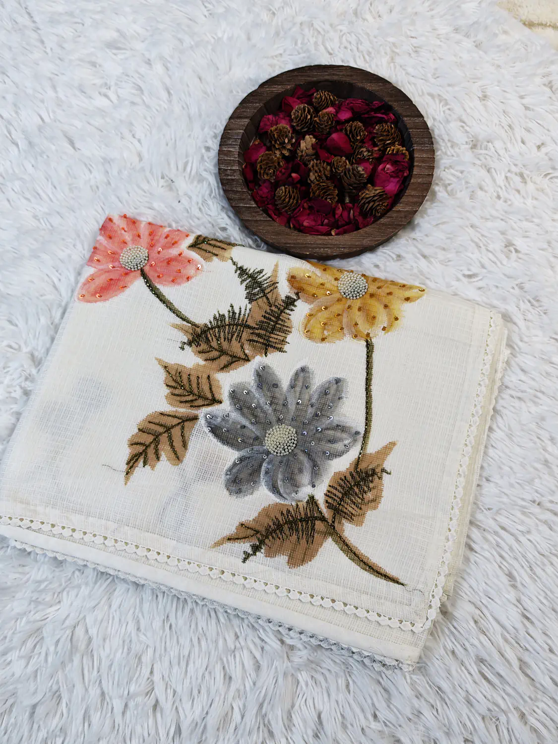 Close view of off-white Kota saree with coral, mustard and grey floral embroidery