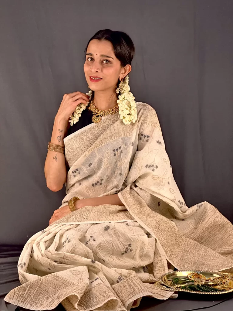 Close-up of model wearing Crushed Banarasi Saree - Black with gold border and dark floral motifs