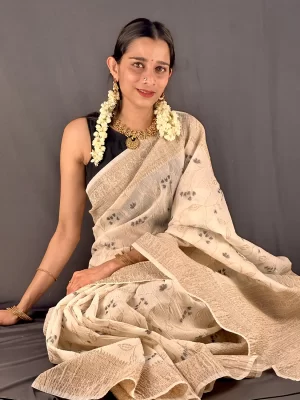 Seated front view of Crushed Banarasi Saree - Black with vine motifs and antique gold border