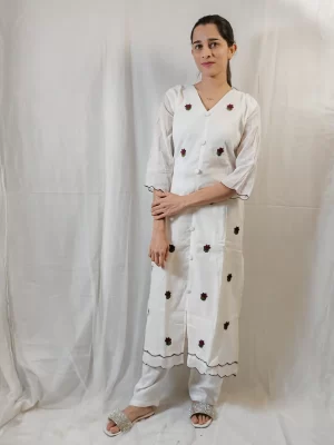 Front angled view of Ruby-Thread White Kurti with matching trousers and scalloped trim