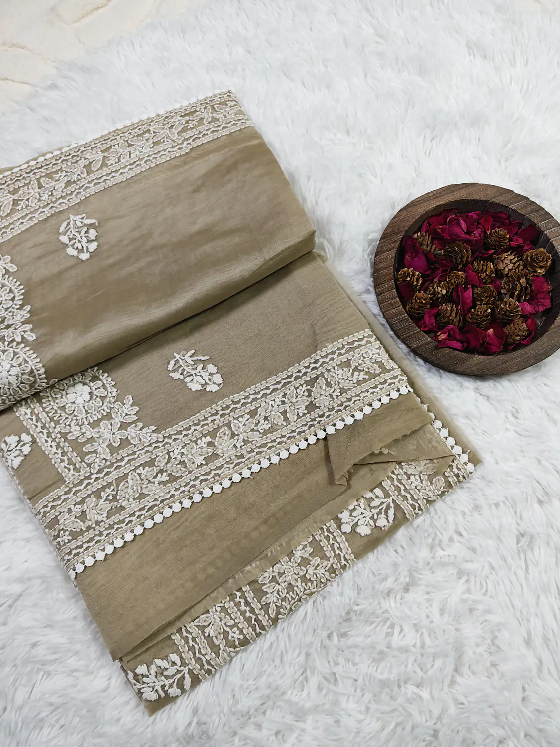 Smokey Taupe Crushed Organza Saree partly unfolded to show white floral borders and small motifs