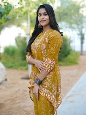 Three-quarter view of mustard C-Line top with floral detailing
