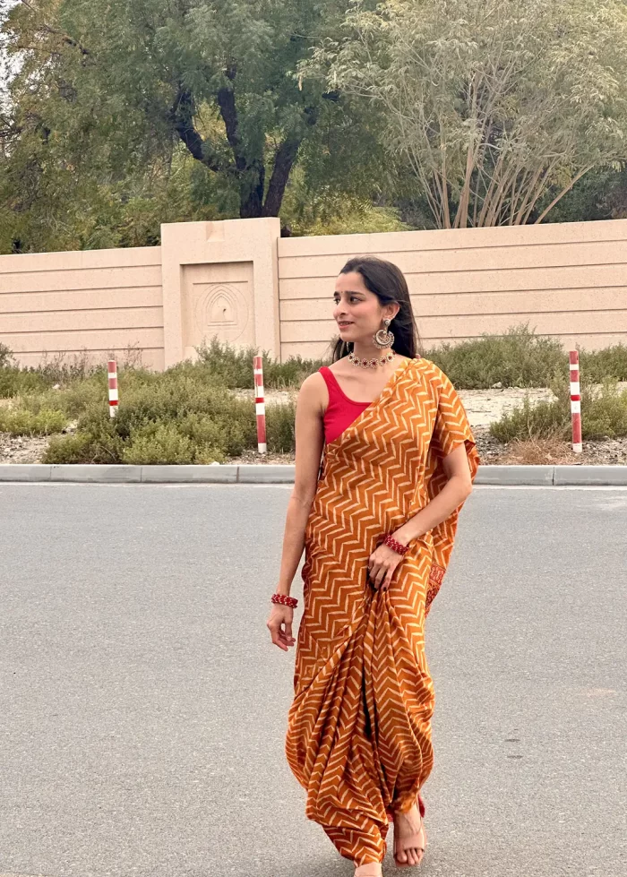IMG_0583 Sunset Mustard zigzag saree in a relaxed outdoor pose
