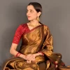 Seated side pose in the Golden Radiance saree