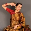 Golden tissue cotton saree styled in a seated pose