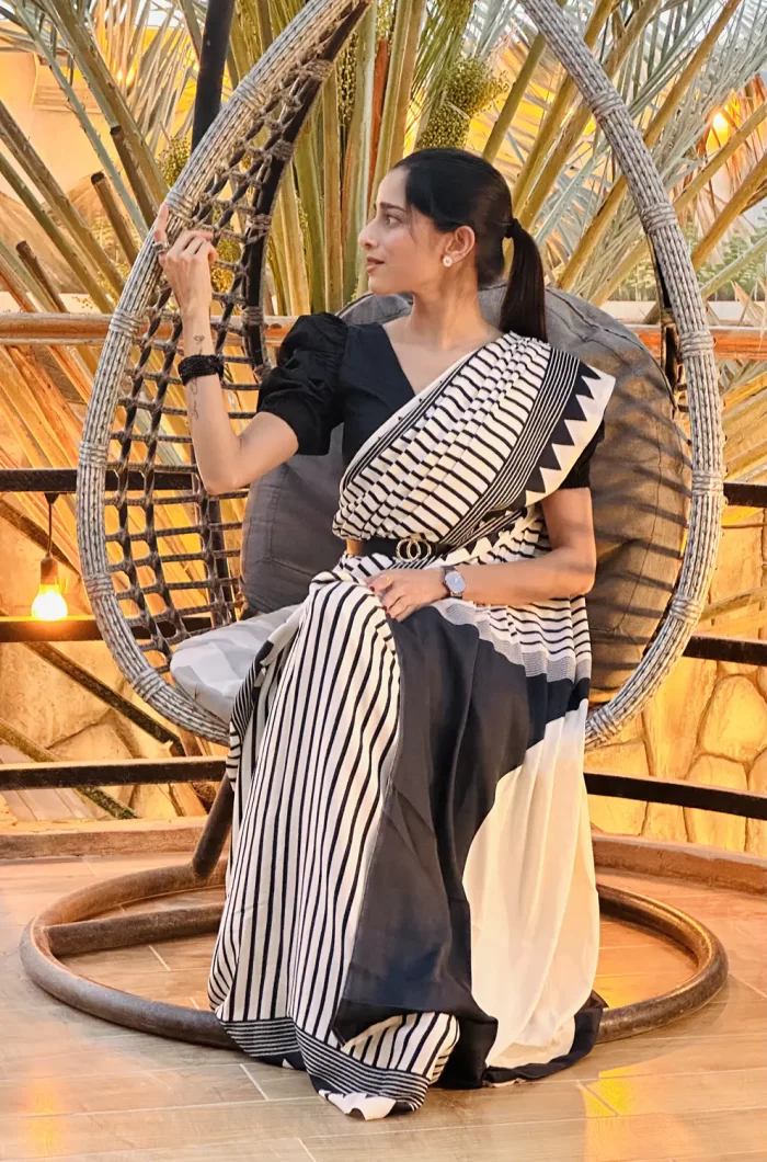 Black and white striped saree drape detail close view