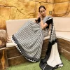 Elegant black and white striped saree draped on model