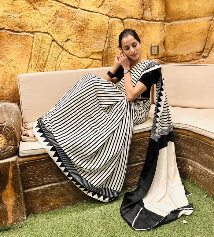 Elegant black and white striped saree draped on model