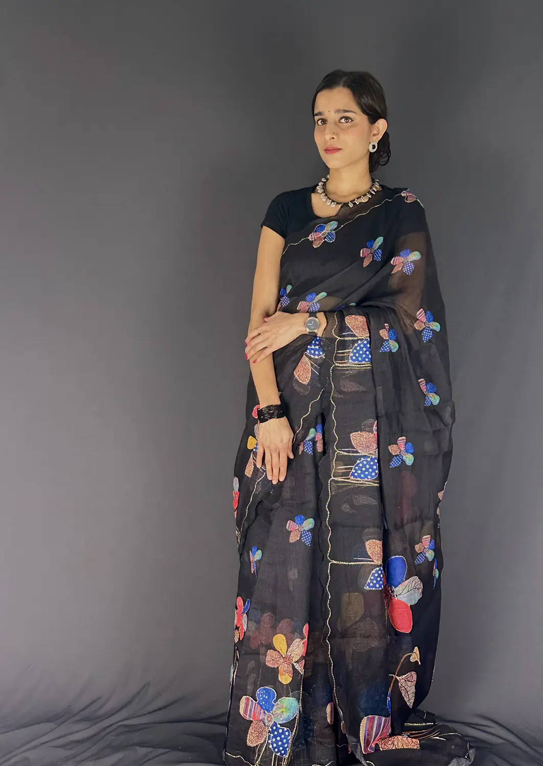 Full-length black linen saree with multicolour floral print and zari detailing