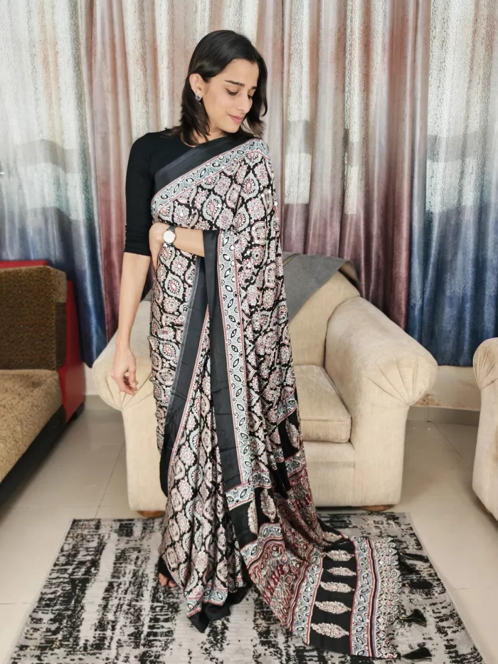 Woman wearing Ajrakh Black Mirror Work Saree with tassel border