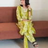 Lime green Ikat printed co-ord set with three-quarter sleeves, seated front view