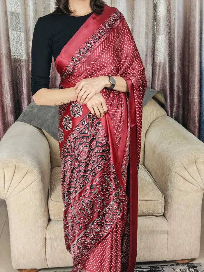 Woman wearing Maroon Modal Satin Silk Saree with decorative border