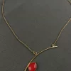 Asymmetric Bar Gemstone Neck Chain with an angled gold-toned bar and red teardrop stone