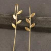 Climbing Vine Ear Cuffs with slender gold-toned stems and textured leaves