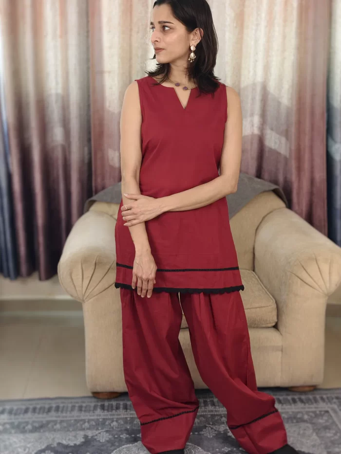 Deep Red Farshi Salwar Set (1) Upper-body view of Deep Red Farshi Salwar Set with sleeveless tunic and black layered trim