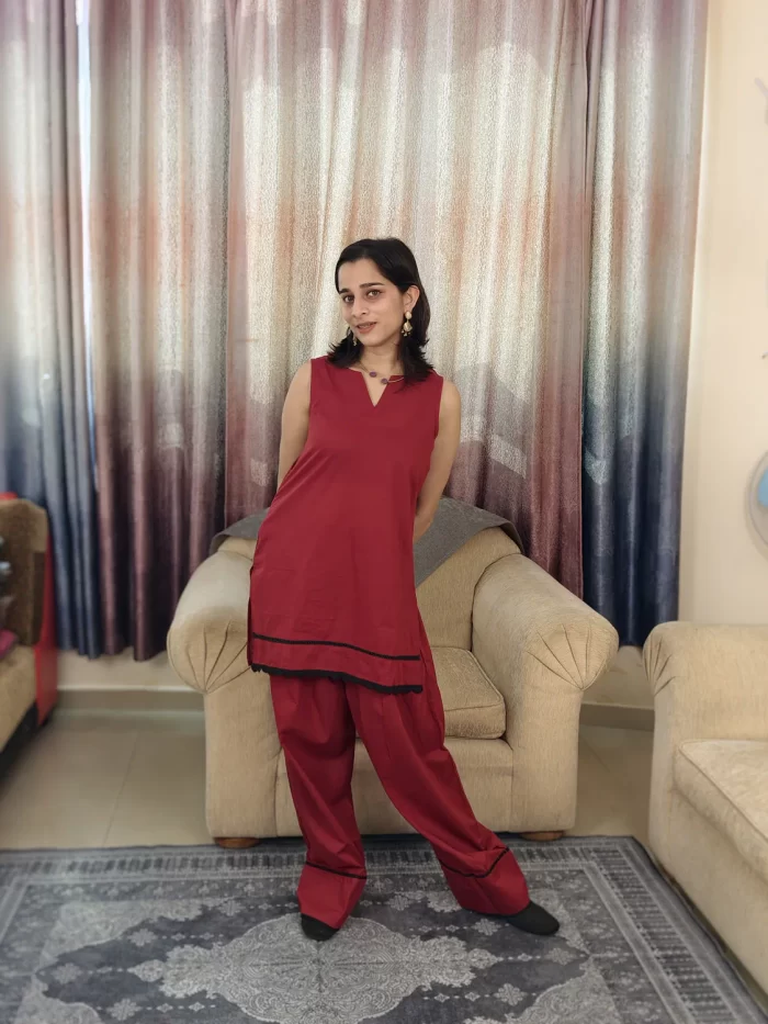 Deep Red Farshi Salwar Set (4) Angled full-length view of Deep Red Farshi Salwar Set with sleeveless tunic and flared salwar