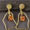 FLOATING STONE EAARING - SAFFRON Saffron Floating Stone Earrings with raw-look stones in sculptural gold-toned frames