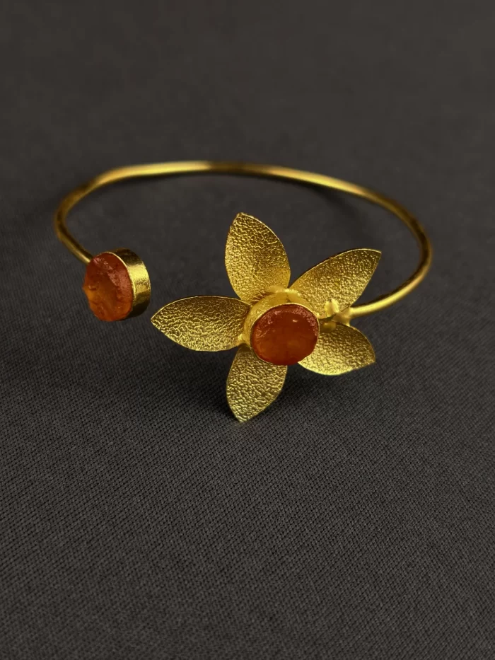 GOLDEN DAHLIA OPEN BANGLE - SAFFRON Saffron Golden Dahlia Open Bangle with a textured five-petal flower and round stones