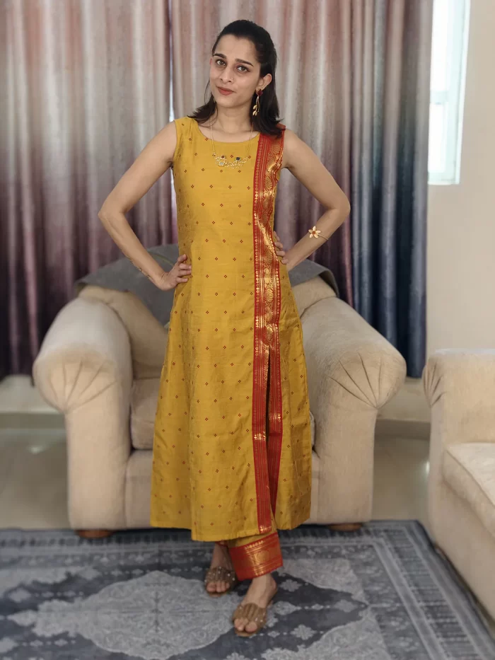 Mustard Yellow Zari Bordered Cotton Silk Coordset (7) Mustard Yellow Zari Bordered Co-Ord Set front view with hands on hips