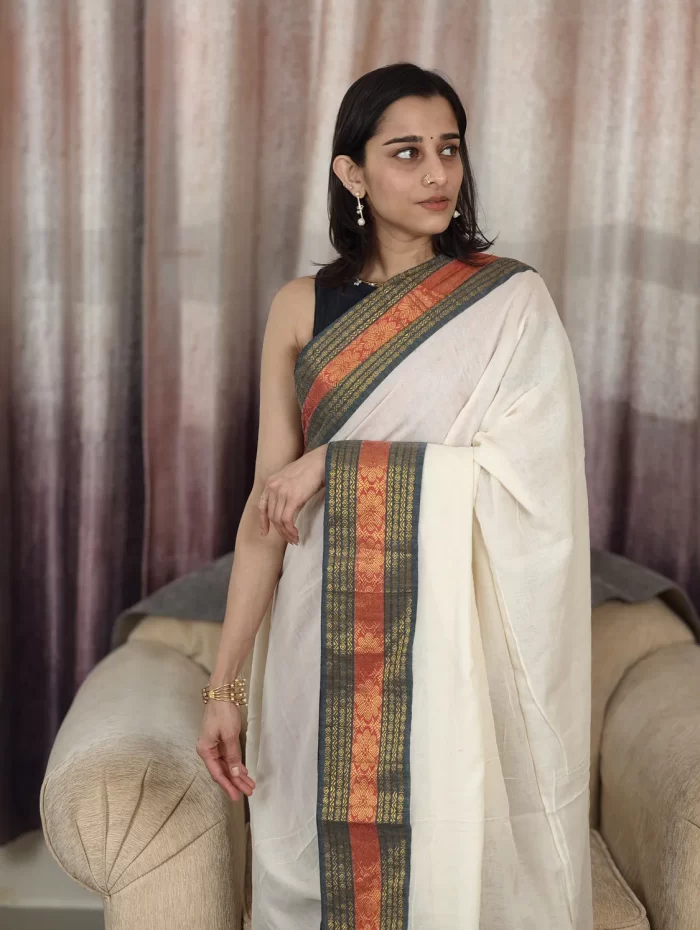 Offwhite Mulcotton Saree with Black & Orange Border (1) Off-White Mul Cotton Saree with Black & Orange Border upper-body front view