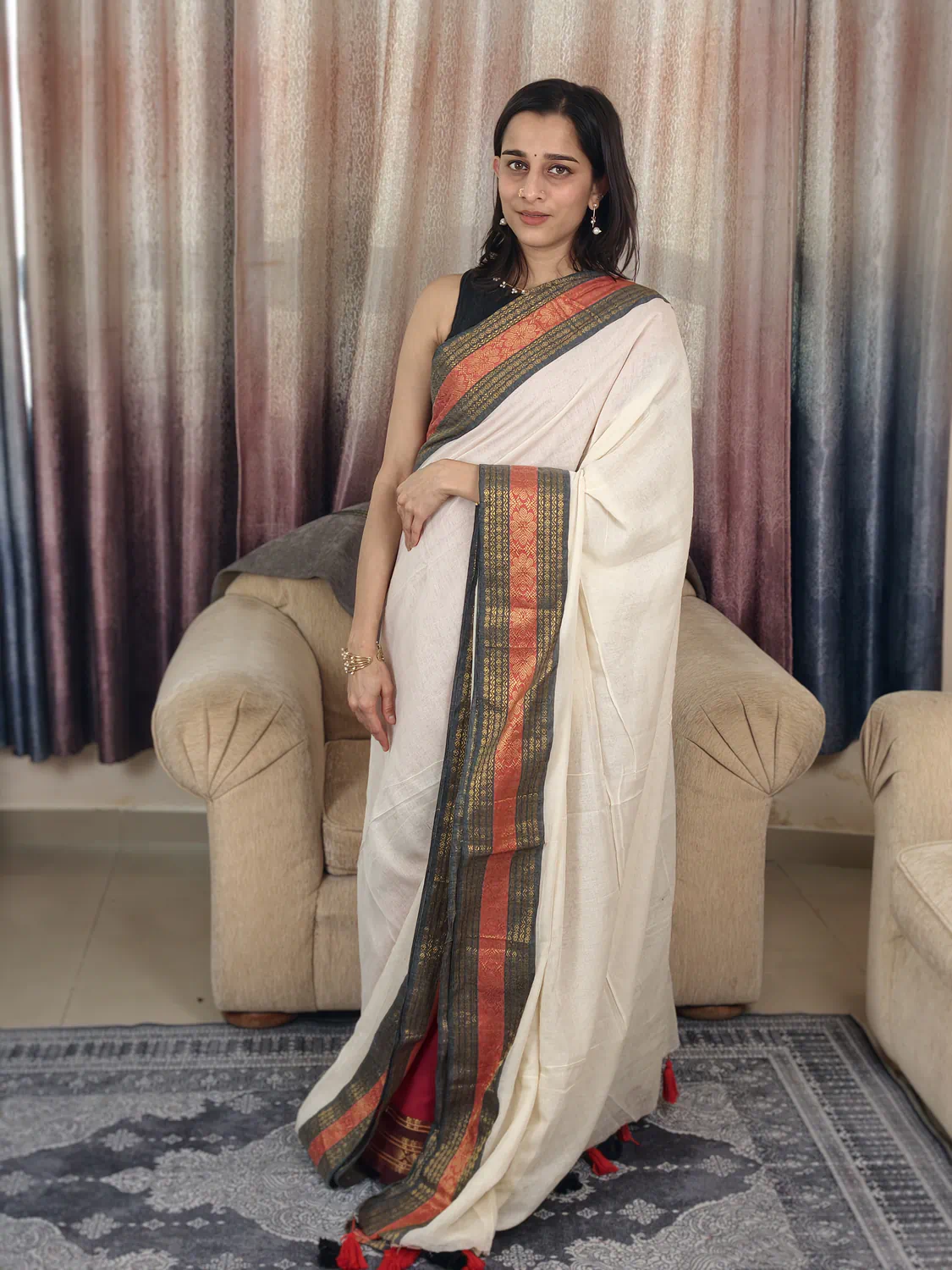 Full-length Off-White Mul Cotton Saree with black and orange woven border