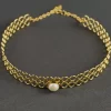 Pearl Honeycomb Collar Choker with an open circular design and central pearl-like accent