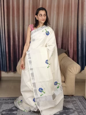 Shangupushpam Hand-Painted Saree close-up showing blue florals on ivory