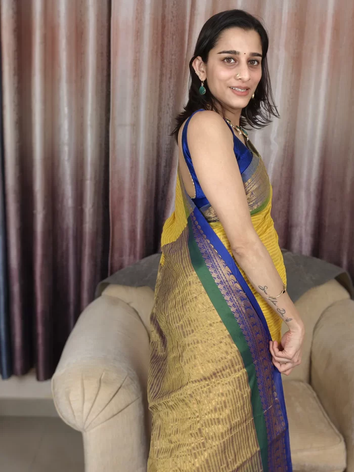 Yellow Mul Cotton Saree with Green & Blue Border (5) Yellow Mul Cotton Saree with Green & Blue Border in a side-facing close-up