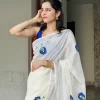 Shangupushpam Hand-Painted Saree – Detail View Close-up of Shangupushpam hand-painted saree showing blue floral motifs and silver border