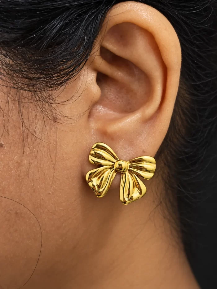 sculpted-bow-statement-earrings-1.webp Gold-tone sculpted bow statement earrings